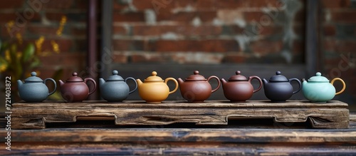 Exquisite Asian Teapots Set on a Rustic Wooden Table: A Perfect Blend of Elegance and Tradition in this Asian Teapots Set on a Wooden Table Display photo