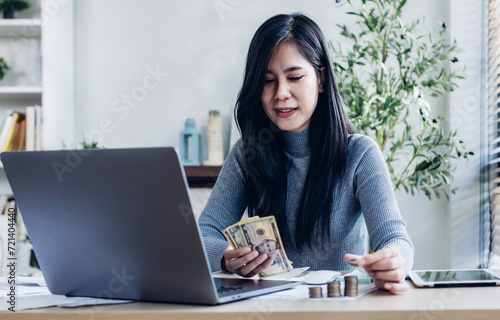 woman working from home concept saving money for finance accounting. Saving money wealth concept, asian business woman hand write management budget for saving cost, cash finance