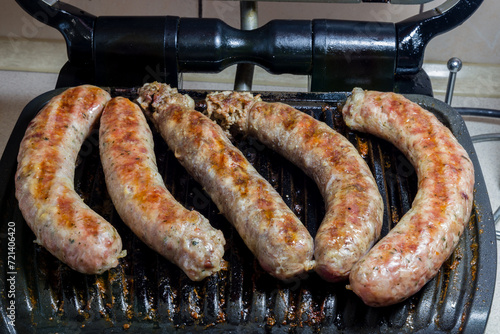 Wallpaper Mural sausages on an electric grill Torontodigital.ca