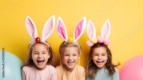 Happy girls in bunny ears celebrating easter photo