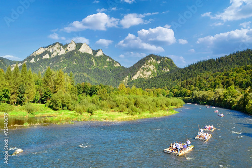 Rafting on the Dunajec river with view on Three Crowns in the Pieniny National Park in summer sunny day. It is a popular tourist attraction in Pieniny mountains, Poland.