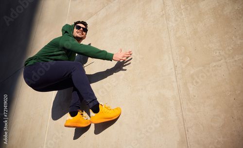 Male freerunner leaping on concrete wall photo