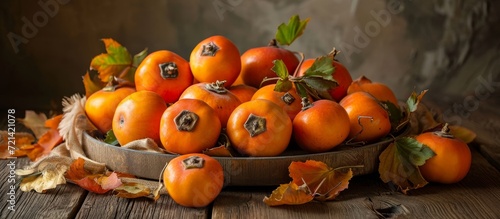 Delicious and Ripe Persimmon Fruit on a Wooden Table: A Delectable Display of Delicious, Ripe Persimmon Fruit Arranged Artfully on a Wooden Table