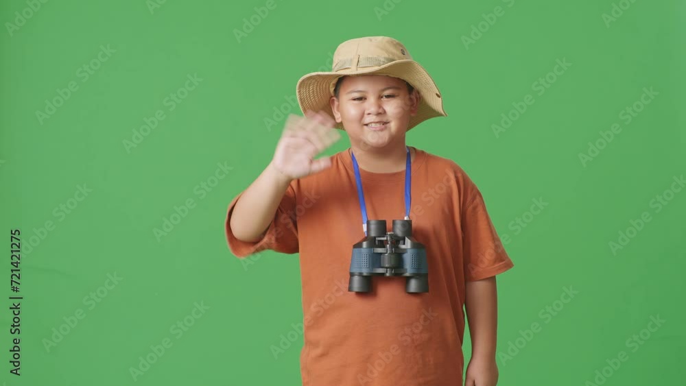 Tourist boy researcher smiling and waving hand on the green screen background
Tourist boy researcher smiling and waving hand on the green screen background
