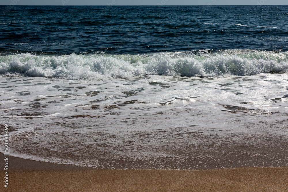 Sandy beach, waves and sea