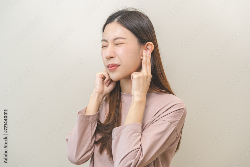 Tinnitus concept, sick asian young woman, girl have ear pain or earache, hand touch plug ear, suffering painful otitis from loud of noisy sound, inflammation. Health care nerve deaf eardrum disease. Tinnitus concept, sick asian young woman, girl have ear pain or earache, hand touch plug ear, suffering painful otitis from loud of noisy sound, inflammation. Health care nerve deaf eardrum disease.