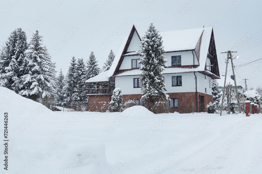 ZAKOPANE, POLAND - JANUARY 18, 2024: A modern highlander's house under the snow.