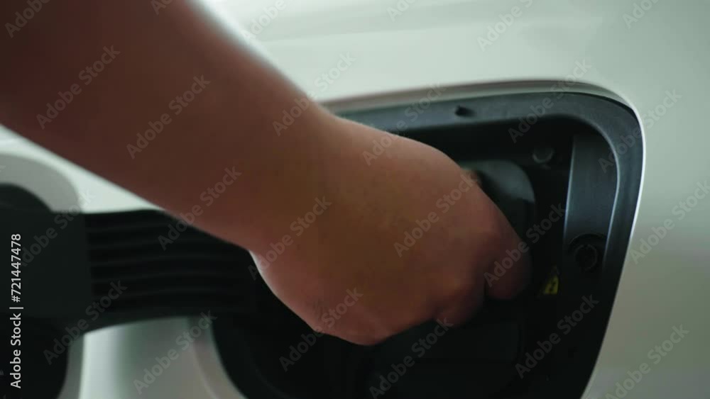 hand unplug power cable supply to charging electric car at home hand unplug power cable supply to charging electric car at home