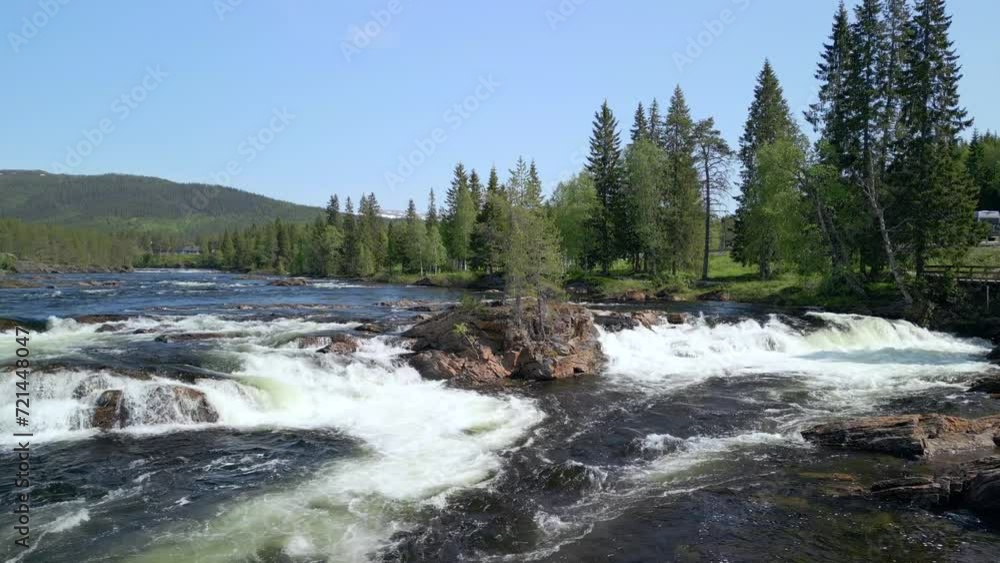 Aerial view of the frothy Namsen River's rapids, surrounded by lush coniferous forests in Namsskogan, Trondelag, filmed by a drone ascending over the water Aerial view of the frothy Namsen River's rapids, surrounded by lush coniferous forests in Namsskogan, Trondelag, filmed by a drone ascending over the water