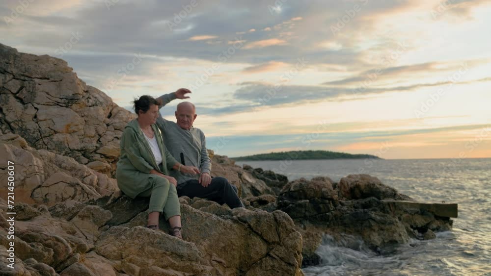 pensioners travel, joyful old man and his wife enjoy their vacation sitting on seashore backdrop of sunset pensioners travel, joyful old man and his wife enjoy their vacation sitting on seashore backdrop of sunset