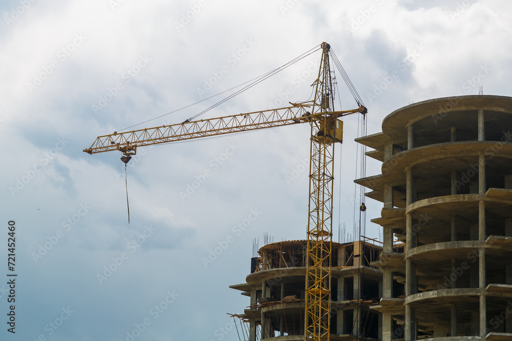 Tower crane on the construction of a multi-storey building in a new area.