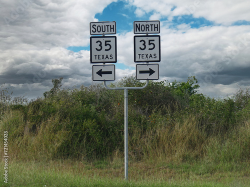 Sign on the road with arrows to the north and south directions of Interstate 35 in Texas.