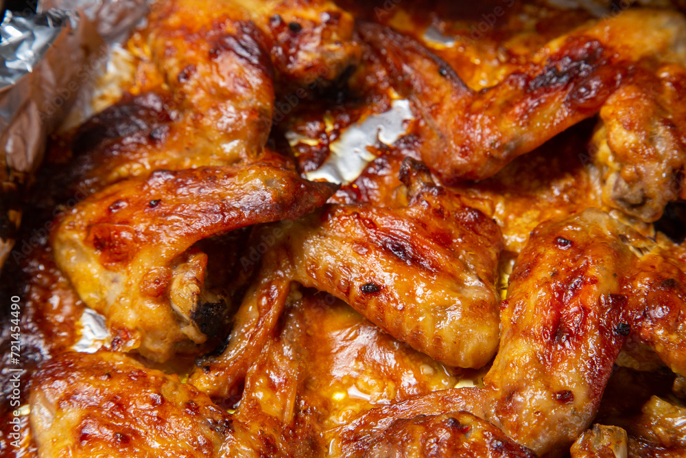 Chicken wings baked in soy sauce and garlic marinade with a crispy crust close-up Chicken wings baked in soy sauce and garlic marinade with a crispy crust close-up