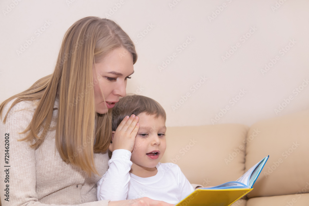 woman reading book to child indoors woman reading book to child indoors