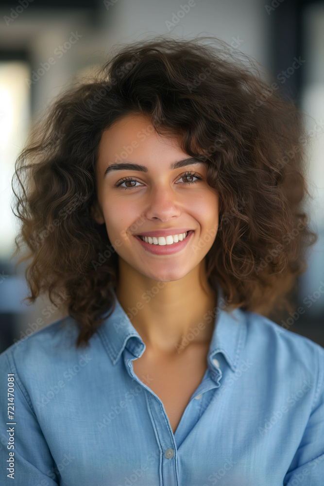 Young woman smiles with confidence in the office. Young woman smiles with confidence in the office.