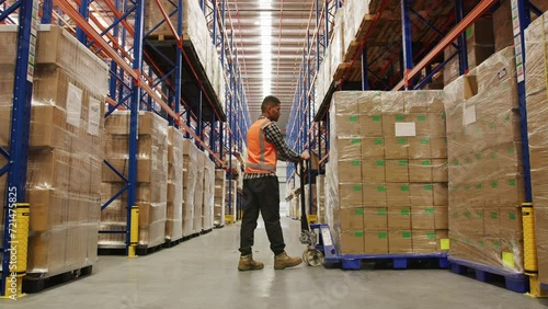 Male worker in the warehouse doing his job photo