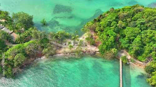 A mesmerizing aerial vista of a lush green tropical coastline, embraced by the crystal-clear waters of the sea. Nature's masterpiece. Sustainable travel concept. Ko Chang, Trat Province, Thailand.
 photo
