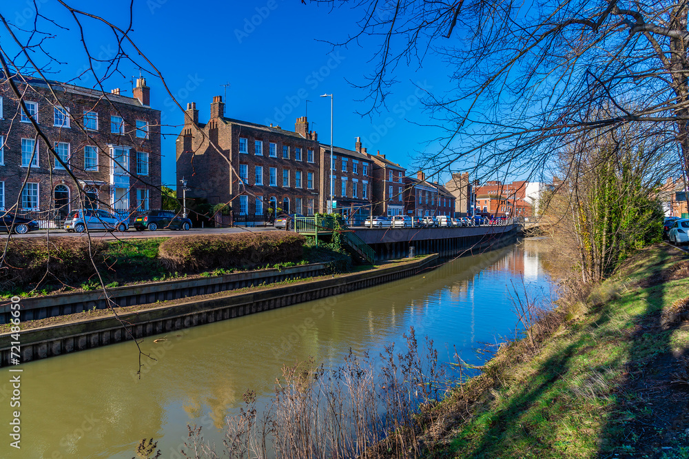 A view up the River Welland opposite Welland Place in the centre of Spalding, Lincolnshire on a bright sunny day