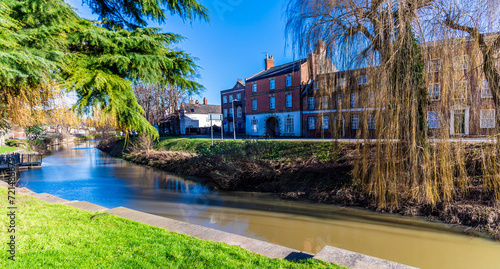 A view beside the Church Street bridge across the River Welland in the centre of Spalding, Lincolnshire on a bright sunny day photo