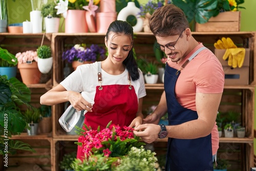 Wallpaper Mural Man and woman florists using diffuser watering plant at flower shop Torontodigital.ca