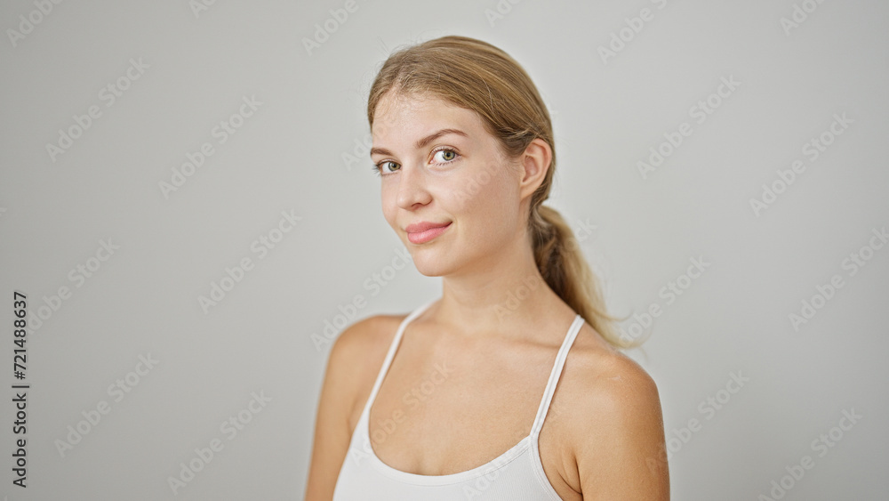 Fototapeta premium Young blonde woman smiling confident standing over isolated white background