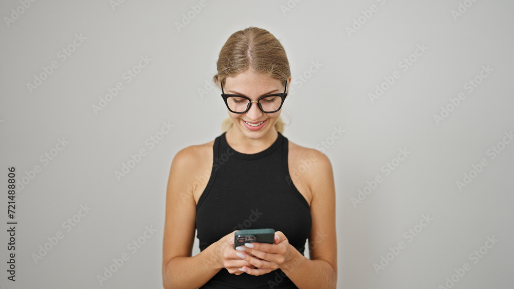 Young blonde woman using smartphone smiling over isolated white background Young blonde woman using smartphone smiling over isolated white background