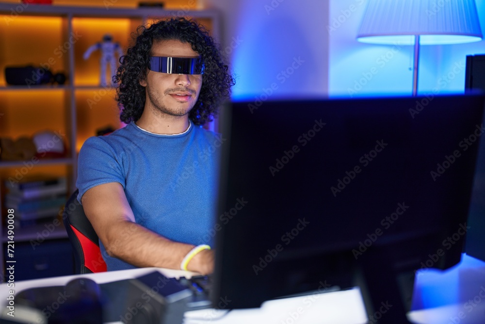 Young latin man streamer playing video game using virtual reality glasses at gaming room Young latin man streamer playing video game using virtual reality glasses at gaming room