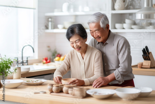 Asian married senior mature couple baking in the kitchen
