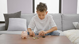 Adorable little blond boy, seriously engaged in counting coins, comfortably sitting on the cozy sofa. indoor relaxation and serious concentration, a valuable lesson in saving and investment at home.