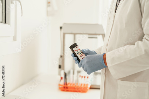 Wallpaper Mural Close up of scientist's hand in gloves putting a small plastic test tube in a microcentrifuge Torontodigital.ca