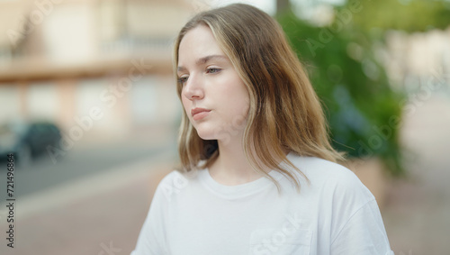Young caucasian woman looking to the side with serious expression at park