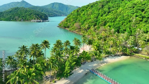 Aerial view of a pristine tropical island, where azure seas kiss golden sands, framed by a vibrant green coastline. Natural wonders concept. Cinematic footage. Ko Ngam island, Thailand. 4K HDR.
 photo