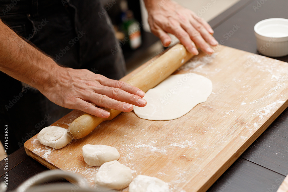 A young guy cooks from dough at home. Manti dumplings A young guy cooks from dough at home. Manti dumplings