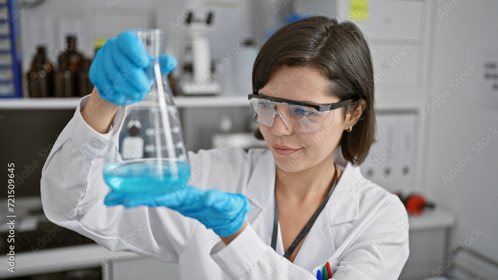 Confident & beautiful young hispanic woman scientist, smiling while holding a test tube, hard at work in a bustling laboratory setting, basking in the glow of her radiant experiments. Confident & beautiful young hispanic woman scientist, smiling while holding a test tube, hard at work in a bustling laboratory setting, basking in the glow of her radiant experiments.