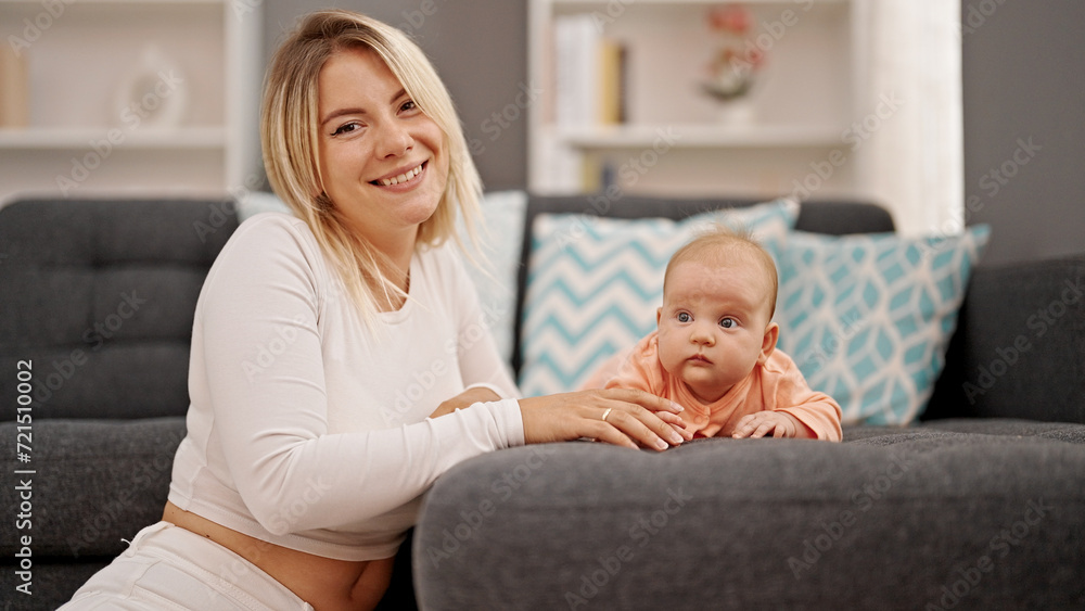 Mother and daughter sitting together smiling at home Mother and daughter sitting together smiling at home