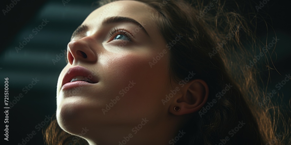 Fototapeta premium A close up image of a woman looking up. Suitable for various applications