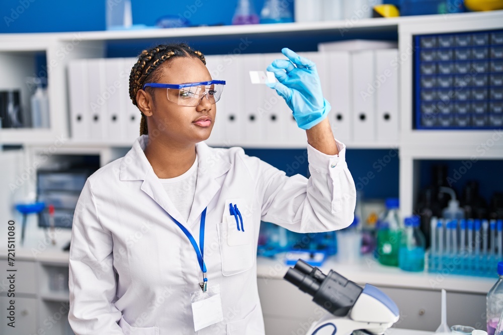 African american woman scientist looking sample at laboratory