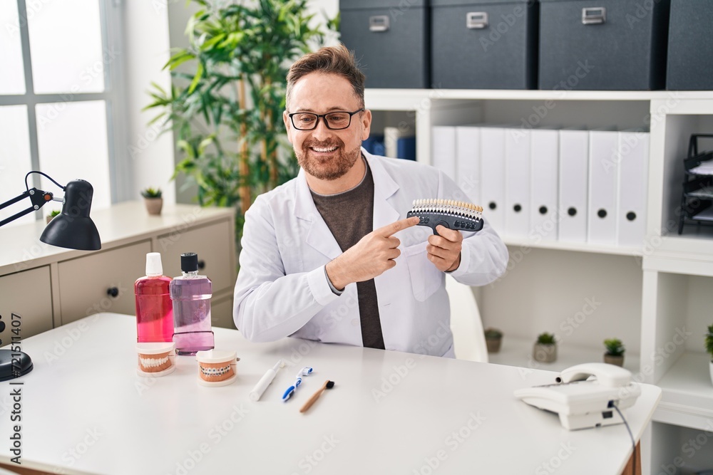 Young caucasian man dentist smiling confident holding whitening test at clinic Young caucasian man dentist smiling confident holding whitening test at clinic