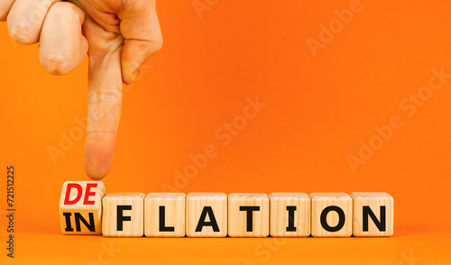 Deflation or inflation symbol. Concept word Deflation Inflation on beautiful wooden cubes. Beautiful orange table orange background. Businessman hand. Business deflation inflation concept. Copy space