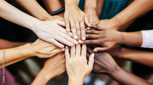 Close-up of diverse female hands piled together in unity photo