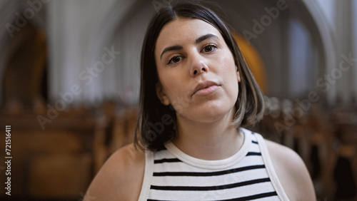 Young beautiful hispanic woman visiting church at Augustinian Church in Vienna