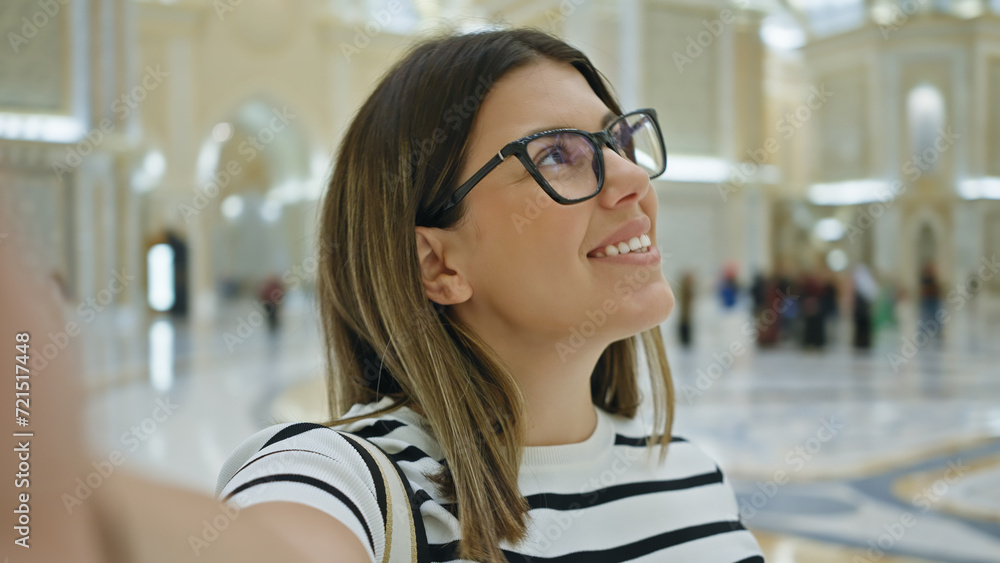 Smiling woman explores qasr al watan palace in abu dhabi, reflecting tourism and architecture. Smiling woman explores qasr al watan palace in abu dhabi, reflecting tourism and architecture.
