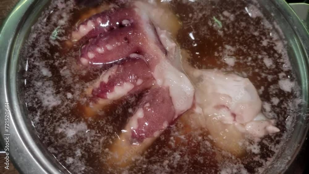 A cook boils squid tentacles in boiling water A cook boils squid tentacles in boiling water