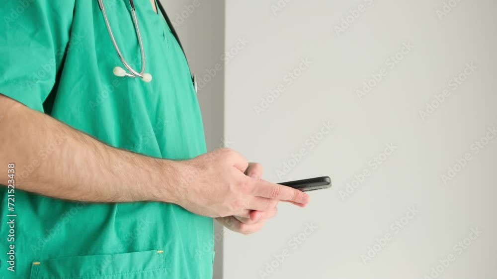doctor in blue surgical gown uses mobile smartphone doctor in blue surgical gown uses mobile smartphone