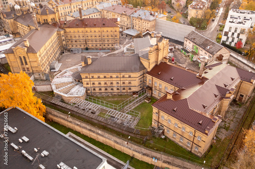 Drone photography of abandoned and old prison in a city during autumn sunset