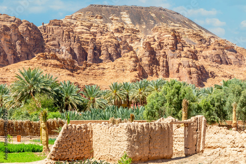 Al Ula ruined old town streets with palms and mountain in the background, Saudi Arabia photo