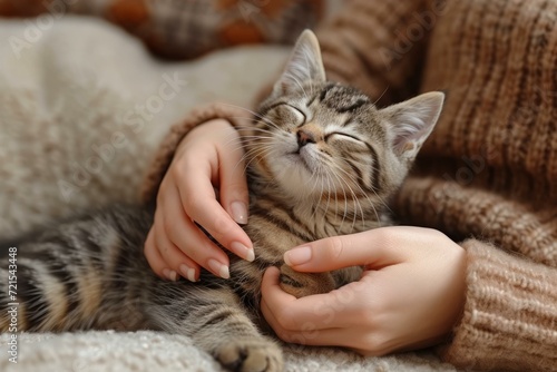 A woman is petting a cat