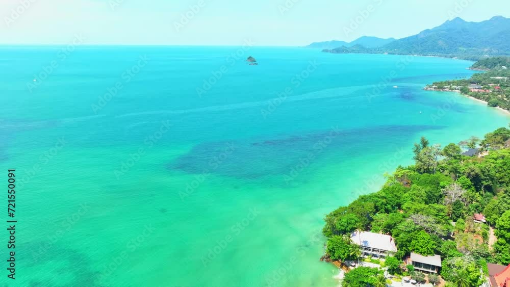 A stunning tropical coastline with pristine beaches, turquoise waters, coastal resorts, lush mountain forests, and a clear blue sky. Exploration and vacation concept. Ko Chang island, Thailand. 4K.
A stunning tropical coastline with pristine beaches, turquoise waters, coastal resorts, lush mountain forests, and a clear blue sky. Exploration and vacation concept. Ko Chang island, Thailand. 4K.
