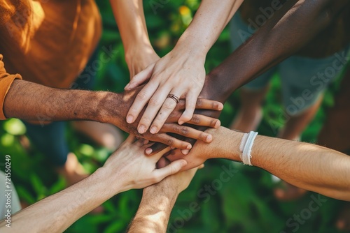 Multiethnic group of people putting their hands together