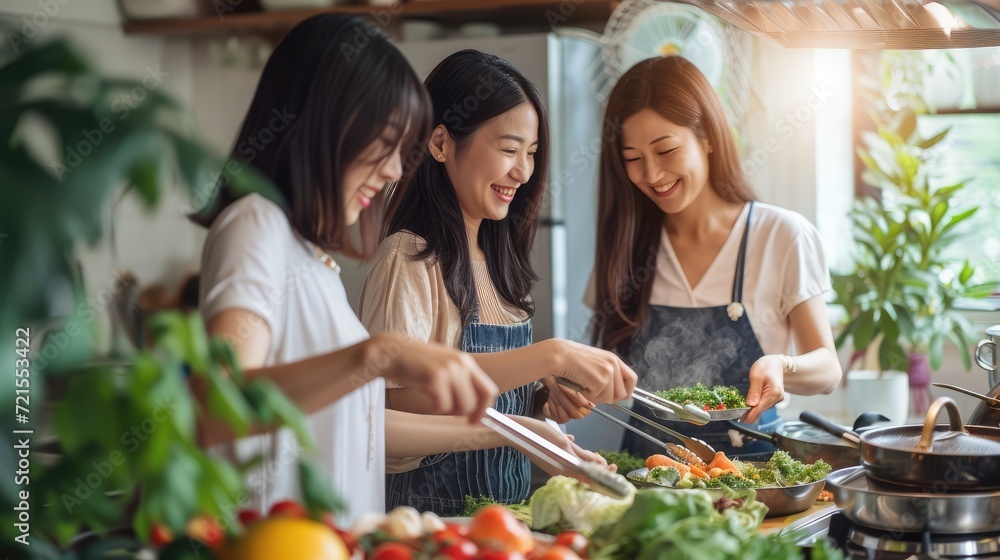 Happy beautiful chinese women friends bonding at home and cooking delicious meal together- Playful asian female adults meeting and having fun